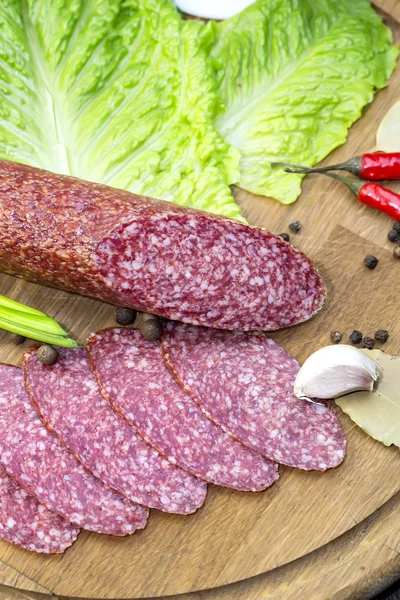 Sausage on a wooden plate — Stock Photo, Image