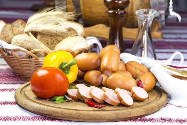 Sausage on a wooden plate — Stock Photo, Image