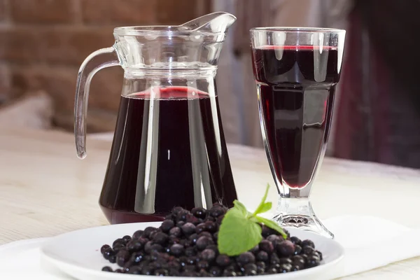 Jar of berry drink on the wooden table — Stock Photo, Image