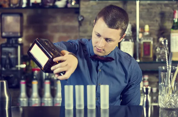 Young man working as a bartender — Stock Photo, Image