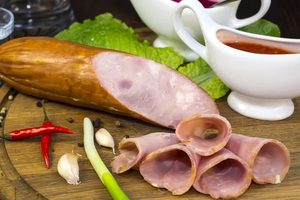 Wurst auf einem Holzteller — Stockfoto