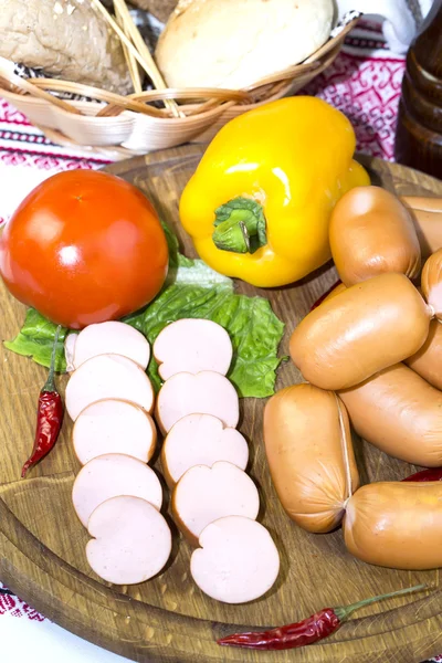 Sausage on a wooden plate — Stock Photo, Image