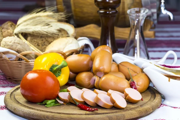 Sausage on a wooden plate — Stock Photo, Image