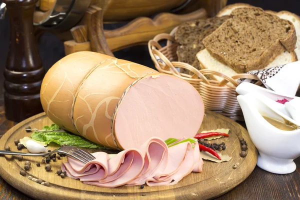 Sausage on a wooden plate — Stock Photo, Image