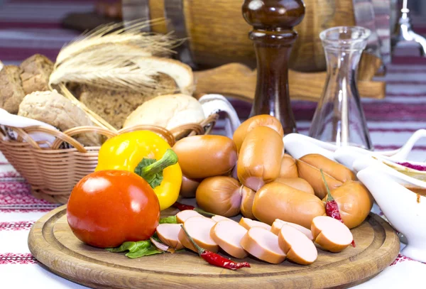 Sausages on a wooden plate — Stock Photo, Image