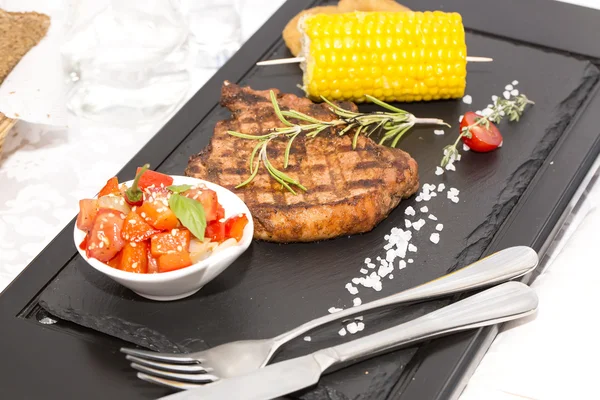 Grilled steak with sauce and greens — Stock Photo, Image