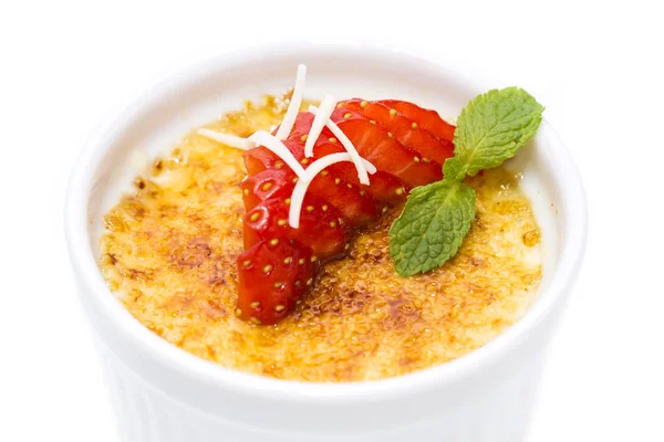 Creme brulee garnished with strawberries — Stock Photo, Image