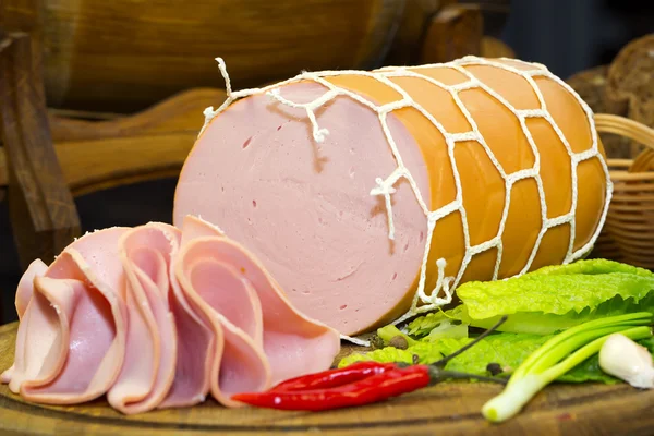 Sausages on a wooden plate — Stock Photo, Image