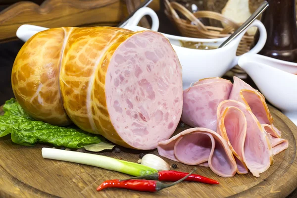 Sausages on a wooden plate — Stock Photo, Image