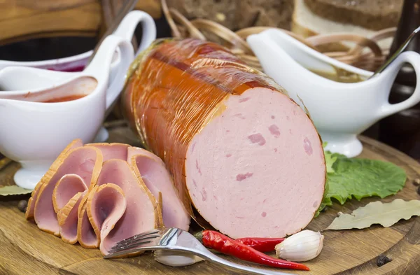 Sausages on a wooden plate — Stock Photo, Image