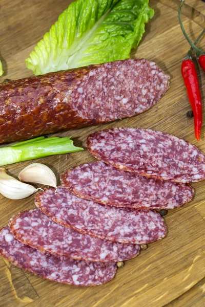 Sausages on a wooden plate — Stock Photo, Image