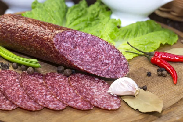 Sausages on a wooden plate — Stock Photo, Image