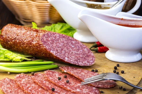 Sausages on a wooden plate — Stock Photo, Image