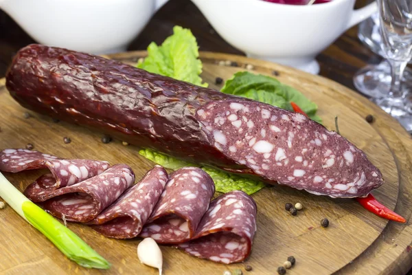 Sausages on a wooden plate — Stock Photo, Image