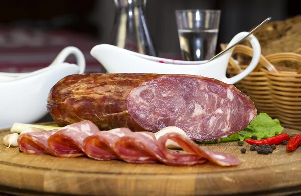 Sausages on a wooden plate — Stock Photo, Image