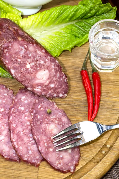 Sausages on a wooden plate — Stock Photo, Image