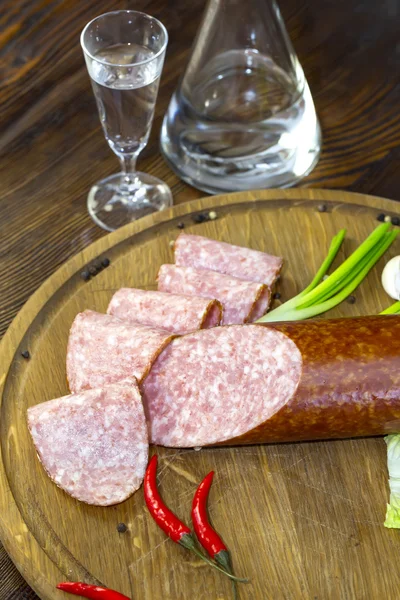 Sausages on a wooden plate — Stock Photo, Image