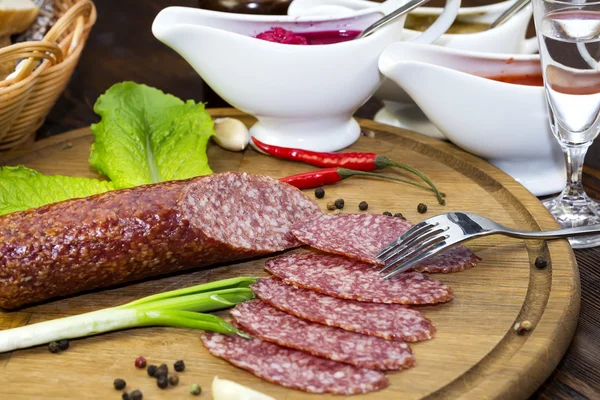 Sausages on a wooden plate — Stock Photo, Image