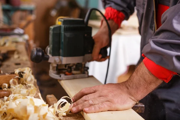 Carpenter at work with electric planer joinery — Stock Photo, Image