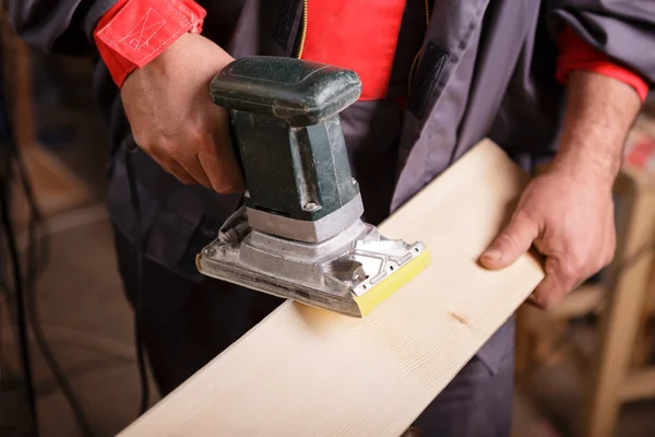 Carpenter at work with the sander — Stock Photo, Image