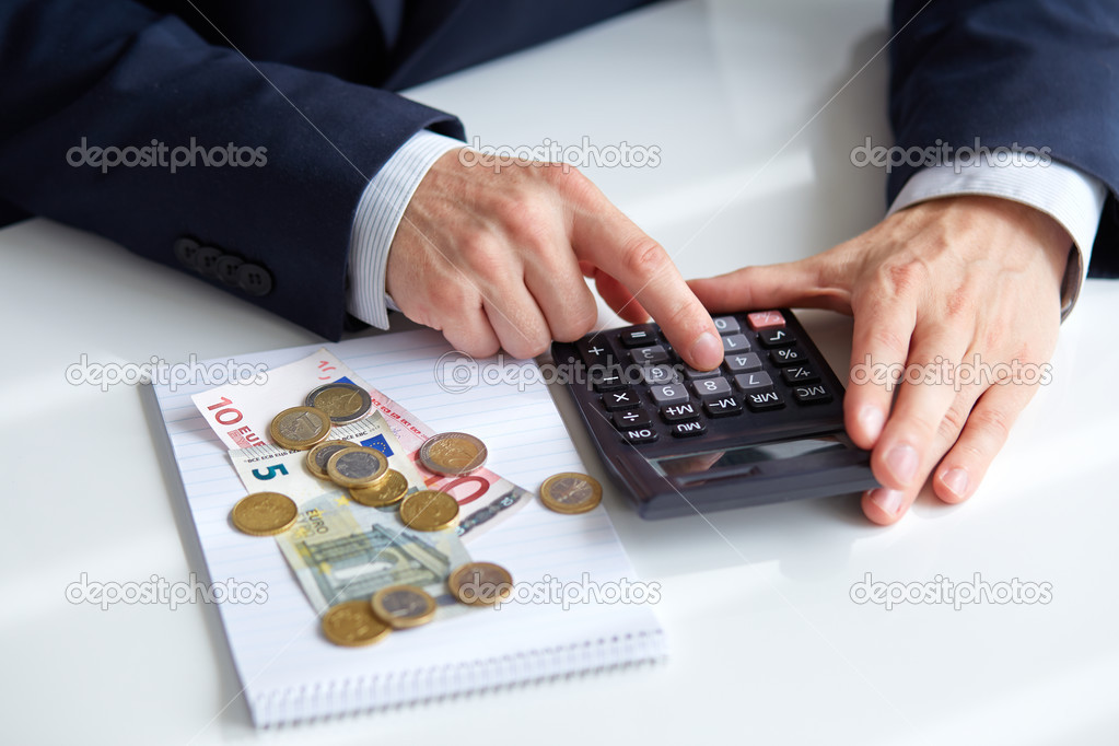 Men's hands with calculator