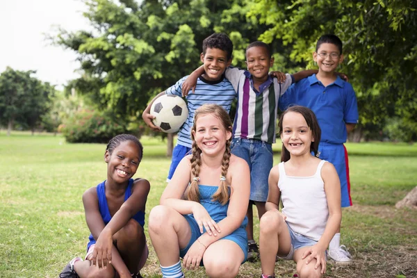 Multiethnic group of happy male friends with soccer ball — Stock Photo, Image