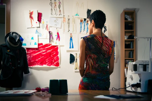 Θηλυκό σχεδιαστής μόδας σκέπτεται σχέδια στο στούντιο — Φωτογραφία Αρχείου