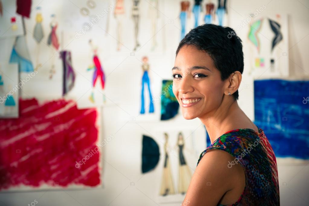 Portrait of happy hispanic young woman working as fashion design