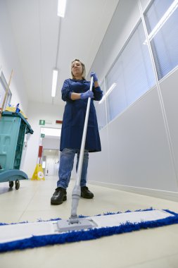 Women at workplace, professional female cleaner sweeping floor i clipart