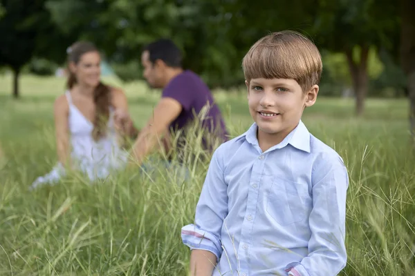 Happy family with son and parents in park — Stock Photo, Image