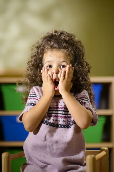 Worried child with mouth open in kindergarten — Stock Photo, Image