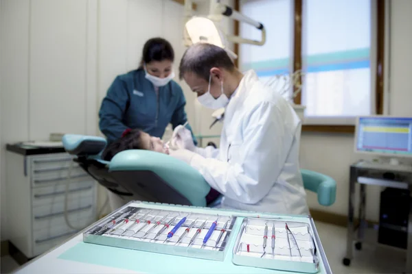 Közeli kép a fogorvos eszközöket a klinikán a beteg fekve a kanapén — Stock Fotó