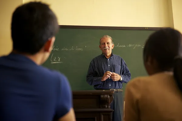 School, professor gesprek met studenten tijdens de les in co — Stockfoto