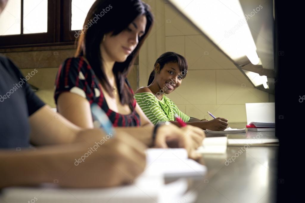 Portrait of happy female student writing, african american woman