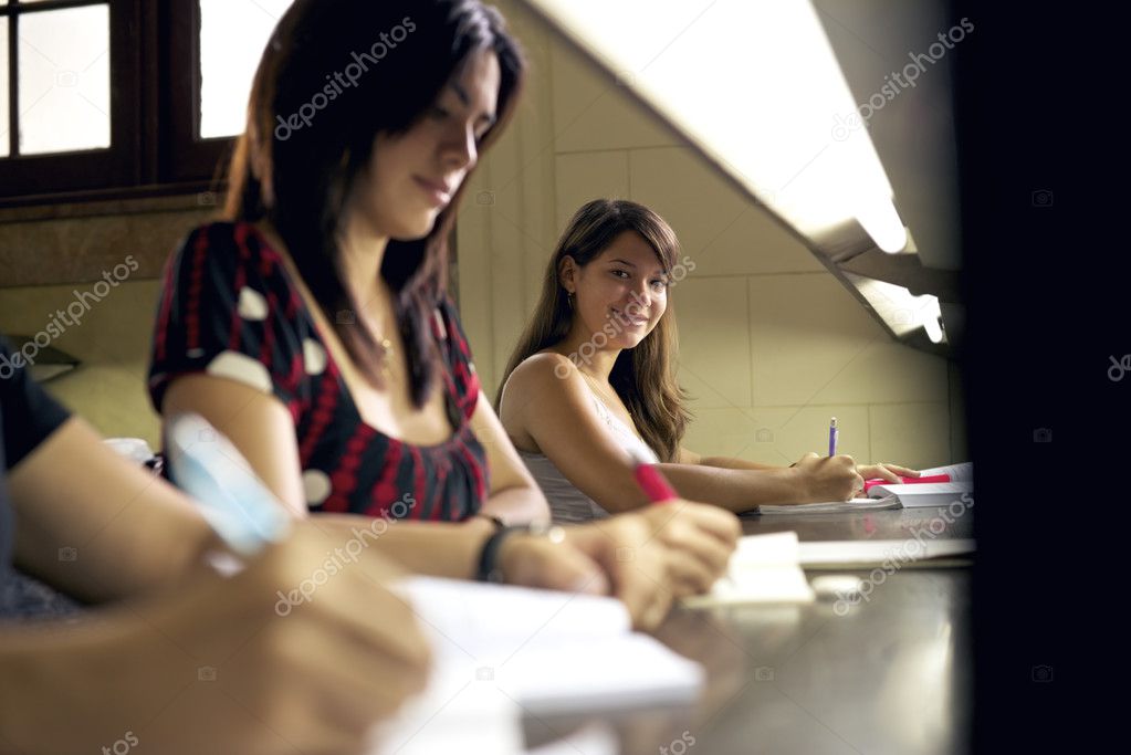 happy female student smiling at camera in college library