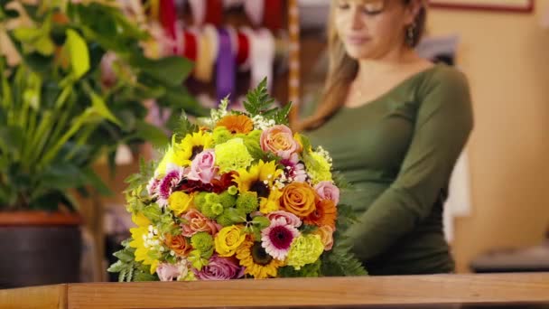 Gelukkige vrouw die werkt als bloemist in bloemenwinkel — Stockvideo