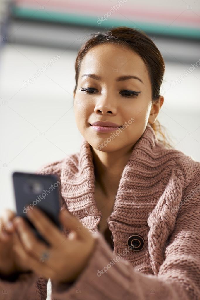 asian girl reading sms on smarthphone