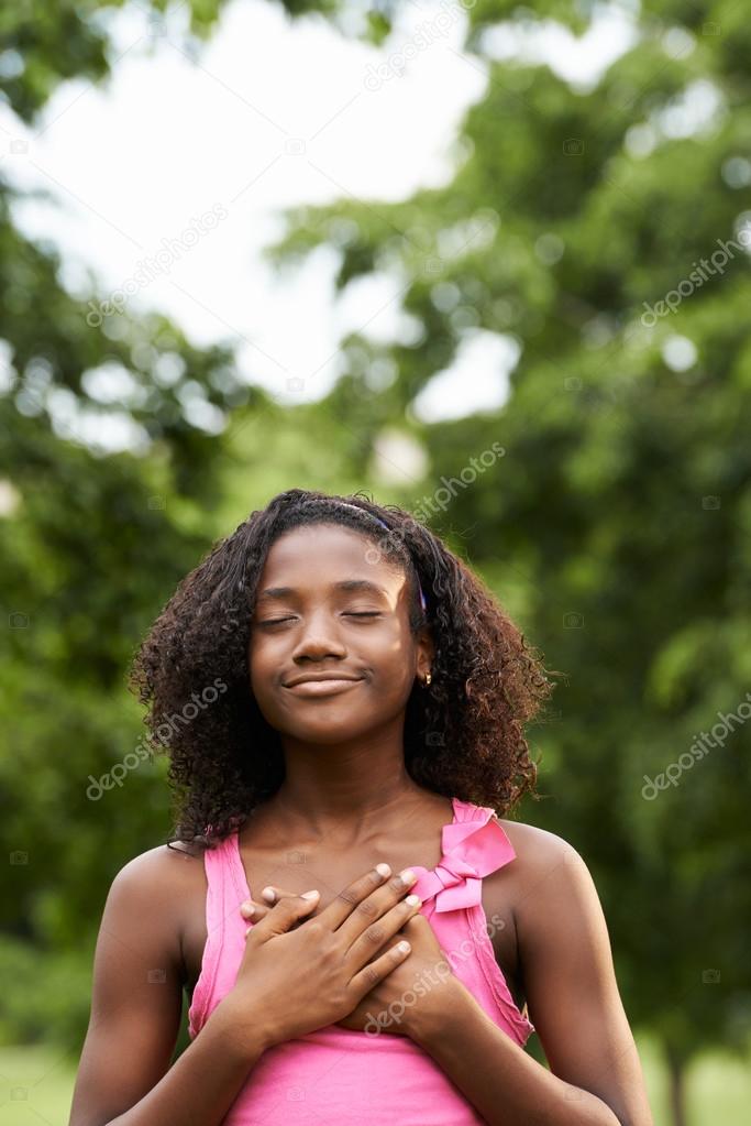 Portrait of black girl in love daydreaming and smiling