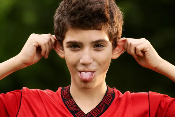 Happy hispanic boy making a grimace at camera — Stock Photo, Image