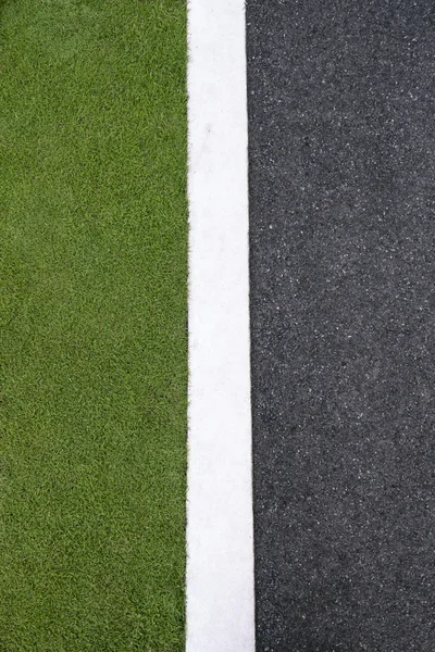 High angle view of asphalt of street and grass — Stock Photo, Image