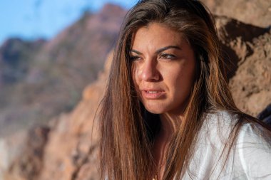 A beautiful hispanic model enjoys the Arizona desert on a winters day clipart