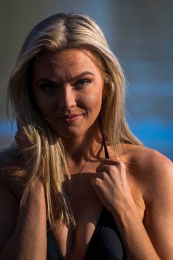 Muhteşem sarışın bir bikini modeli göl kenarında poz verirken yaz havasının tadını çıkarıyor..