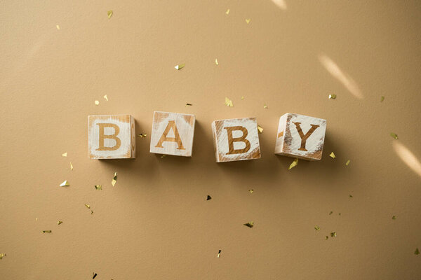 Gender Neutral Baby Blocks on Tan Background