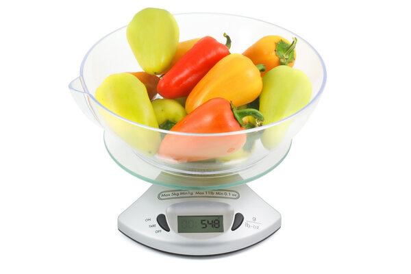Colorful peppers weighed on kitchen scales