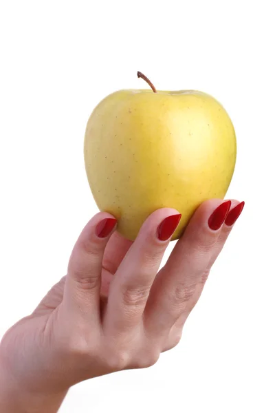 Yellow apple in woman's hands — Stock Photo, Image