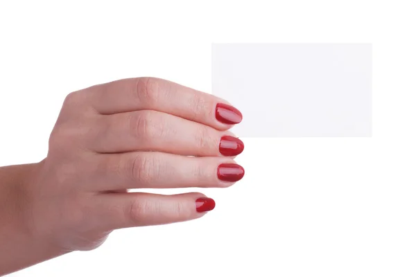 Mão feminina com manicure vermelho segurando um cartão de visita — Fotografia de Stock