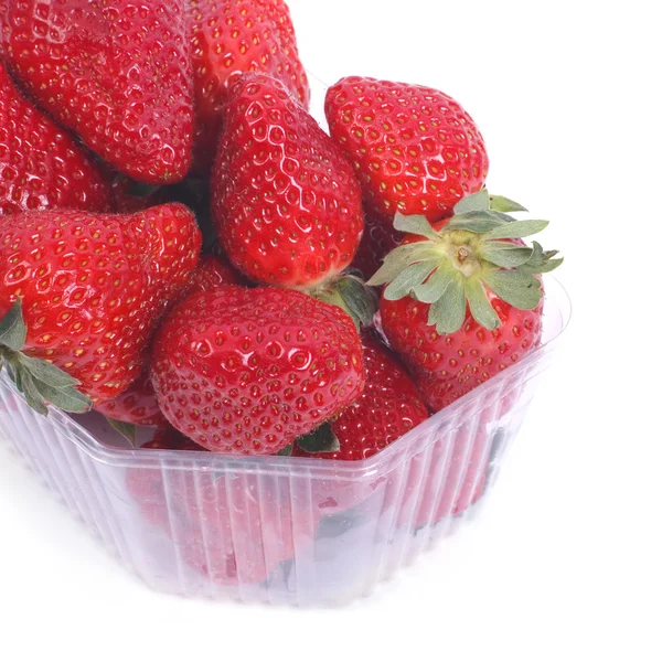 Fresh ripe juicy strawberries in a plastic container isolated — Stock Photo, Image