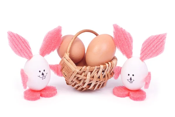 Basket with Easter eggs and two rabbits isolated on white — Stock Photo, Image