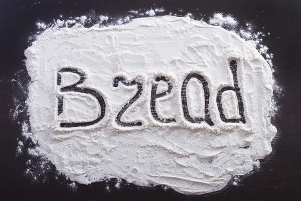 Handwritten inscription "Bread" made with flour — Stock Photo, Image