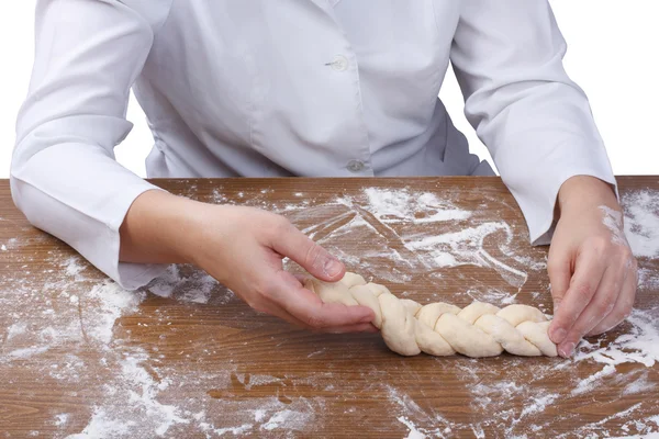 Braiding Challah dough baker on a wooden table flour — Stock Photo, Image